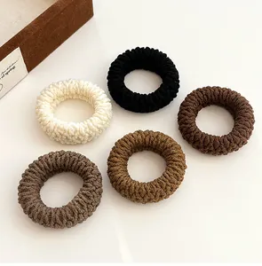 Set of five thick elastic hair bands in neutral coffee tones with ribbed knit texture