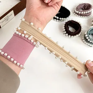 Wide elastic hair scrunchies with white pearls shown in various elegant colors
