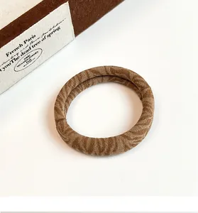 Close-up of soft brown wavy texture hair scrunchie with durable elastic core