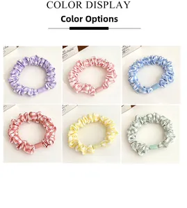 Detail view of colorful gingham hair scrunchies with frosted beads in six pastel colors