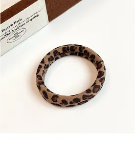 Macro shot of a leopard print elastic scrunchie with soft fabric texture and vintage design
