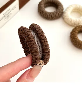Detail showing thick knitted texture of coffee and cream high elasticity hair scrunchies