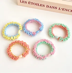 Set of 5 colorful bicolor chiffon scrunchies with plastic buckles on a white background