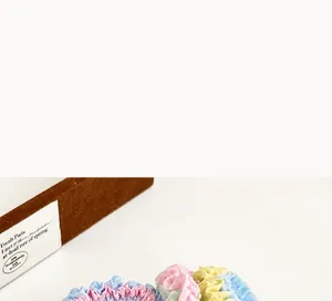 Detailed macro view of colorful pleated fabric hair ties in sweet macaron pastel tones