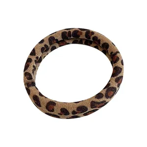 Classic leopard print elastic hair tie with soft fabric texture on a white background