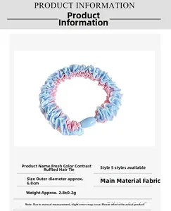 Detail view of contrast lace hair tie with dimensions showing 6.8cm diameter and blue bead