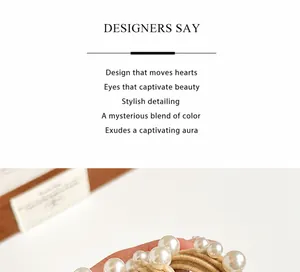 Close-up of elegant pearl hair tie with smooth white faux pearls and elastic woven band
