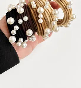 Detailed close-up of high-elasticity hair ties with elegant faux pearl embellishments