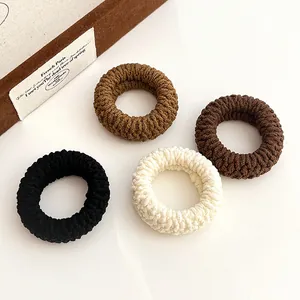 Set of four durable thick elastic hair ties in neutral earth tones with ribbed texture