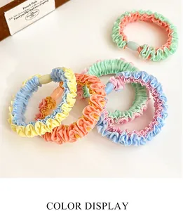 Detailed view of candy color ruffled scrunchies with decorative oval resin beads