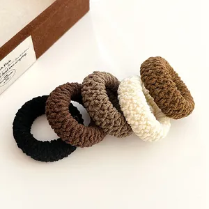 Five-pack of elastic knit hair ties in earth-toned colors on a clean white background