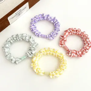 4-piece set of plaid fabric hair scrunchies in pastel purple, green, yellow and pink
