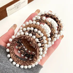 Leopard and zebra print hair ties with pearl embellishments for high ponytail styling