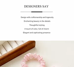 Close-up of light pink pleated organza hair scrunchie with soft satin sheen texture