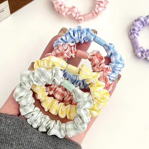 Set of colorful gingham hair scrunchies in pastel tones with matte plastic buckles