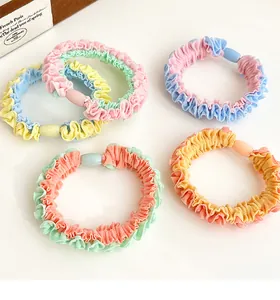 Detailed view of colorful pastel pleated scrunchies with smooth resin connectors