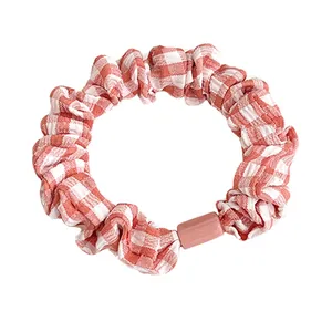 Pink and white gingham scrunchie with cute decorative bead for high ponytail hairstyles
