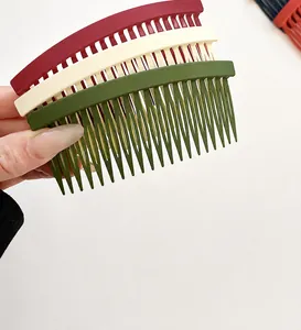 Close-up of matte textured hair comb set in dark green, beige, and wine red colors