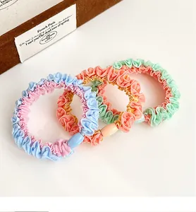 Three-piece set of macaron-colored accordion pleat elastic hair ties with plastic buckles