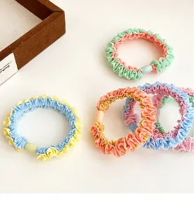 Set of 5 colorful ruffle scrunchies with plastic bead accents in vibrant pastel tones