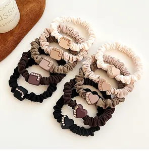 Set of 9 elastic hair ties in neutral earth tones with rhinestone heart and square charms