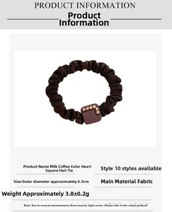 Detail of coffee brown scrunchie with crystal cube charm and dimensions information