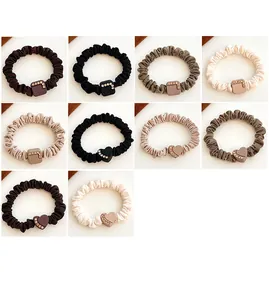 Detail showing various colors of heart and square rhinestone elastic hair ties
