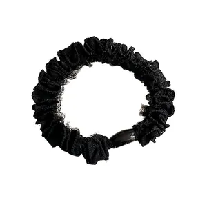 Coletero negro elegante con volantes y cuenta ovalada decorativa para peinados varios