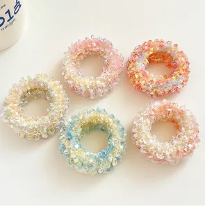 Detailed view of 5-piece macaron colored mesh hair scrunchies with pleated textures