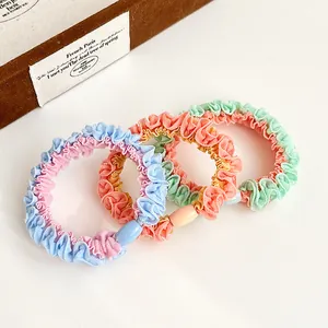 Three-piece set of candy-colored pleated hair scrunchies with decorative oval plastic beads