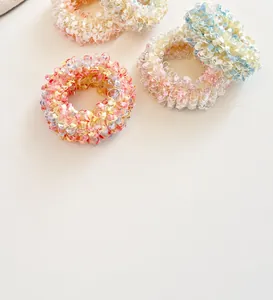 Detailed view of colorful pastel scrunchies with thick elastic core and textured fabric
