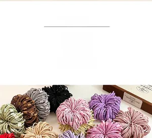Close-up of colorful braided elastic hair ties with matching square decorative beads