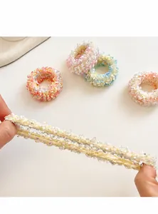 Macro view of high-elasticity hair ties showing stretchable texture and pastel colors