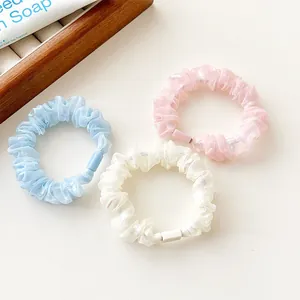 Three-piece pastel chiffon scrunchie set in light blue, white, and pink soft fabric