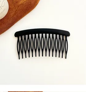 Detail of a matte black 16-tooth hair side comb with anti-slip hollow design