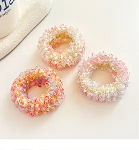 Detail of three pastel ice cream colored elastic hair ties with soft textured fabric