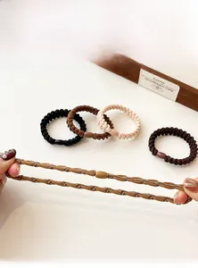 Macro detail of high-elasticity braided hair ties showing durable texture and plastic buckle