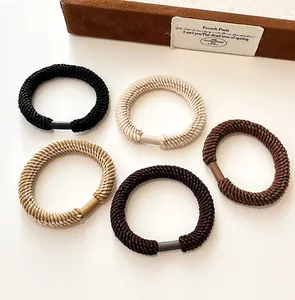 Detail of high-elasticity seamless hair ties in earth-toned thick ribbed knit fabric