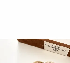 Macro shot of durable braided elastic hair tie in beige and brown colors with spiral texture