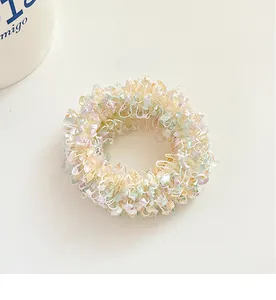 Detail of pastel macaron pleated hair scrunchies in light yellow, green, and purple shades