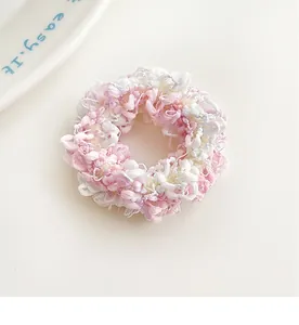 Close-up of the textured knit pink and white candy-colored elastic hair scrunchie