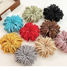 Detailed view of nine colorful braided elastic hair ties in a vibrant variety of shades