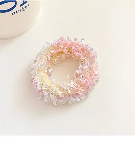 Close-up of pink and white lace scrunchie with soft pleated fabric and gradient colors