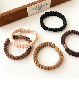 Detailed view of high-elasticity braided spiral hair ties in five assorted earthy tones