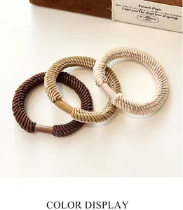 Detailed macro view of three elastic braided hair ties in coffee, brown and beige colors