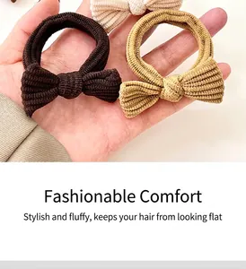 Detail view of corduroy bow hair ties in beige and brown with ribbed texture