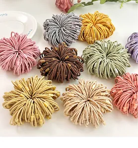 Detailed macro view of colorful multi-strand elastic hair ties with square buckles