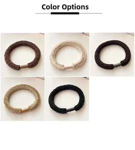 Detailed macro view of woven elastic hair ties with cylindrical connectors in five colors