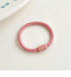 Detail of pink ribbed elastic hair tie with matching resin connector for kids