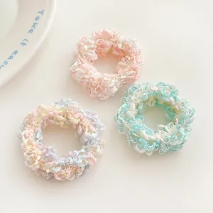 Three colorful plush candy-colored elastic hair ties for ponytails in a sweet style